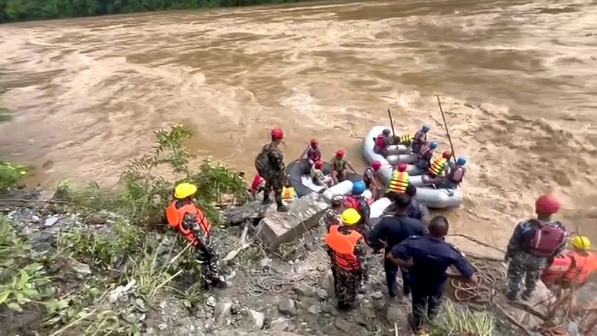 PTI : Nepali Army troops and others during a rescue operation after buses were swept away by a landslide, in Chitwan district, Nepal